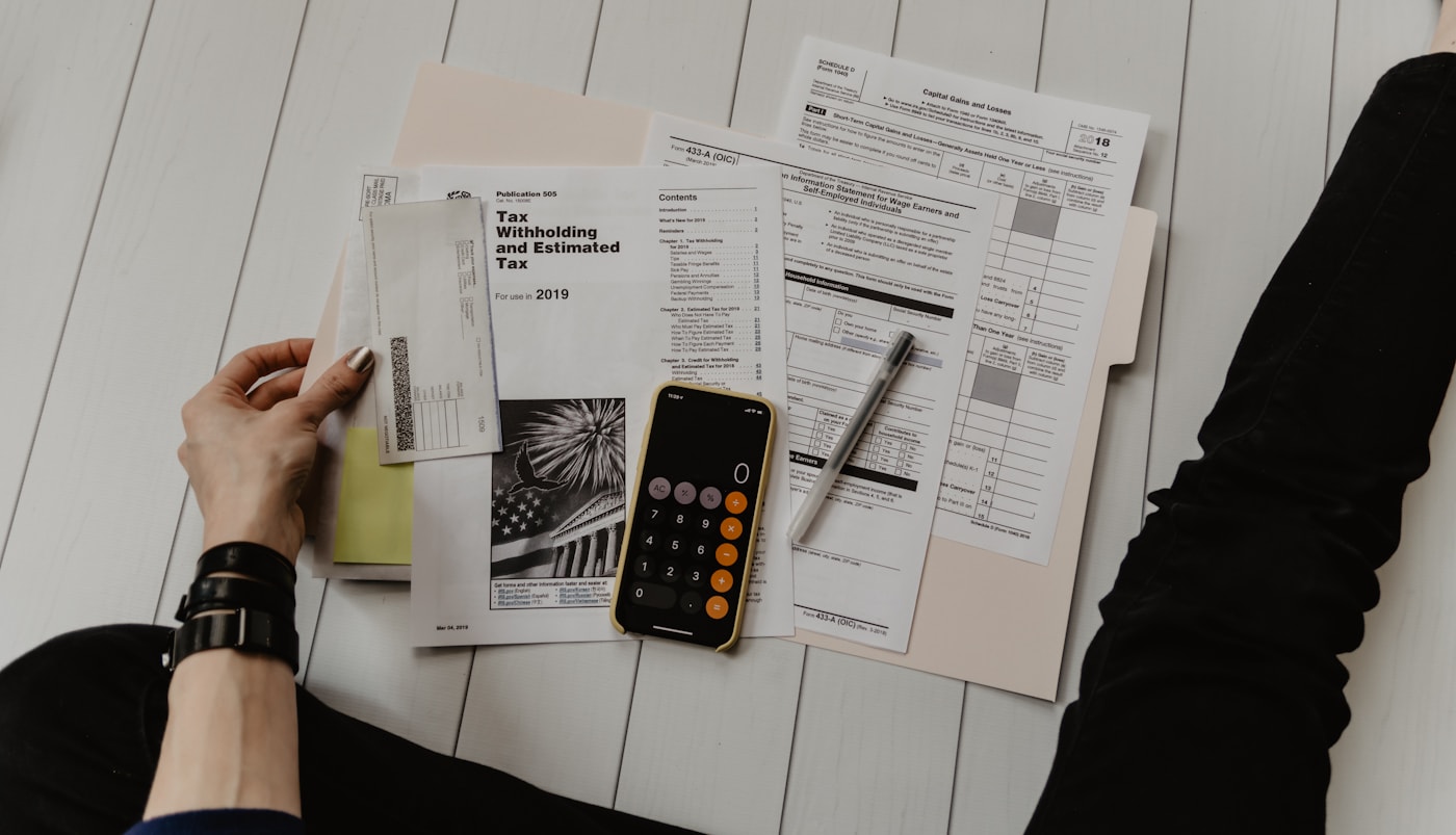 Customer-specific documents prepared beside a laptop